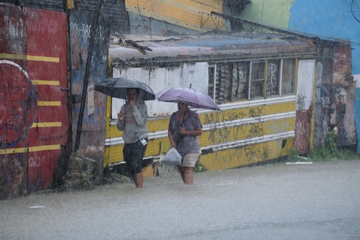 People wade through a street flooded by rains caused by Tropical Storm Melissa in Santo Domingo, Dominican Republic, Friday, Oct. 24, 2025. (AP Photo/Ricardo Hernandez) People wade through a street flooded by rains caused by Tropical Storm Melissa in Santo Domingo, Dominican Republic, Friday, Oct. 24, 2025. (AP Photo/Ricardo Hernandez)