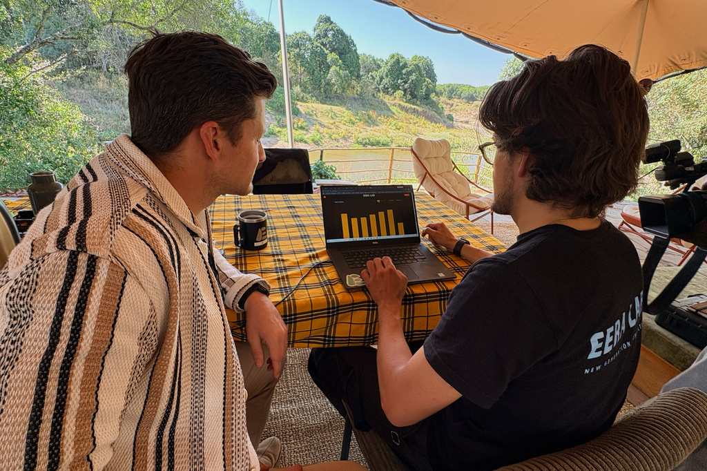 In this photo taken with a smartphone, Loic Amado, founder of Emboo Camp and Era Lab, checks the battery charge of an electric safari van with a colleague at Emboo Camp in the Maasai Mara, Kenya, Saturday, Aug. 29, 2026. (AP Photo/Allan Olingo)