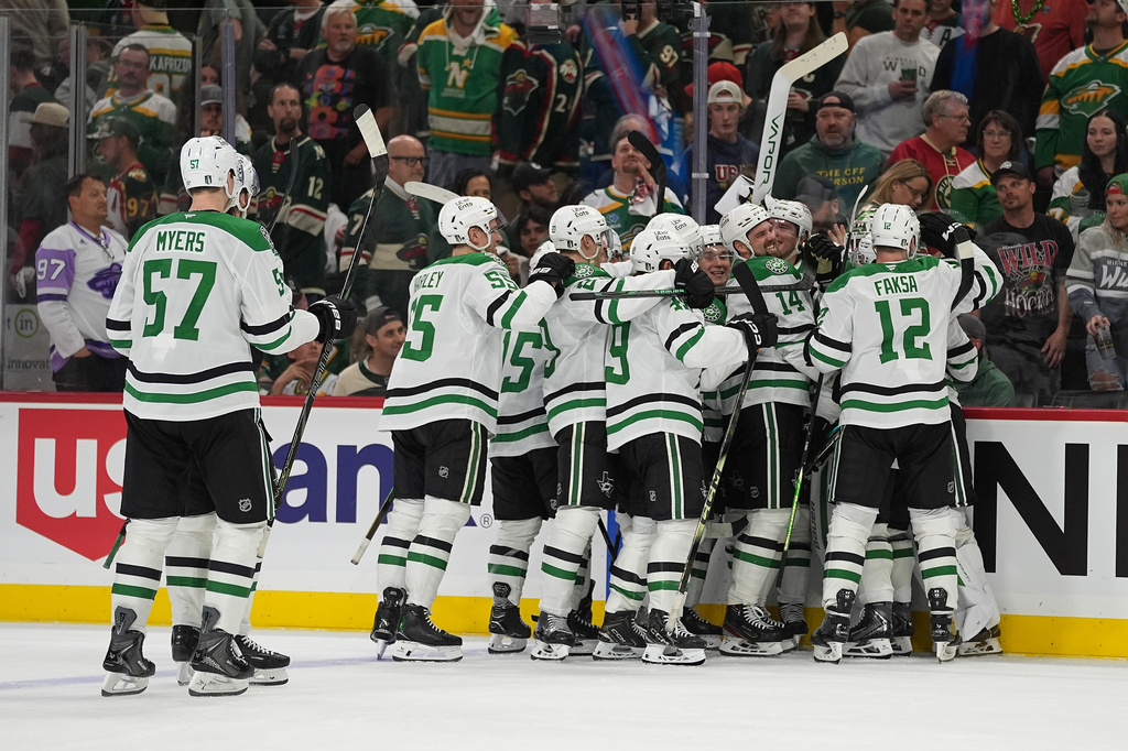 Dallas Stars players celebrate after the double overtime win against the Minnesota Wild of Game 3 in the first round of the NHL Stanley Cup hockey playoffs early morning Thursday, April 23, 2026, in St. Paul, Minn. (AP Photo/Abbie Parr)