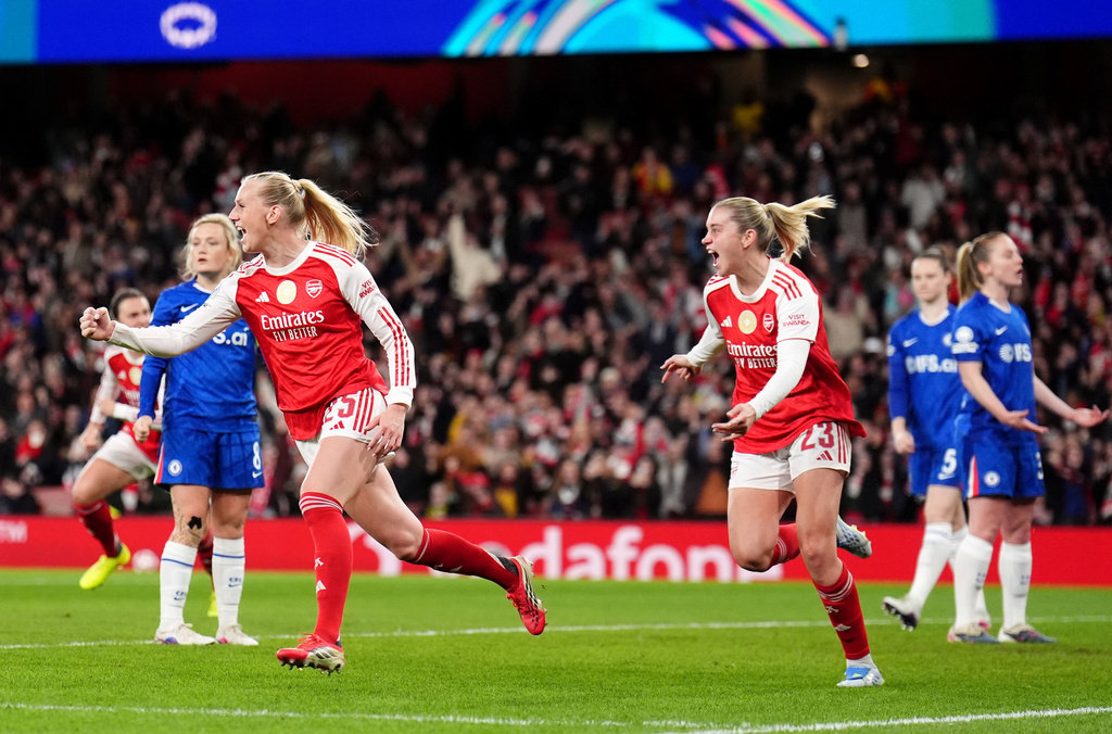 Arsenal's Stina Blackstenius, left, celebrates scoring their side's first goal of the game during the Women's Champions League soccer match between Arsenal and Chelsea in London, Tuesday, March 24, 2026. (John Walton/PA via AP)