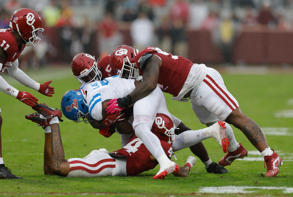 Mississippi running back Kewan Lacy (5) is tackled by Oklahoma defensive lineman Damonic Williams (52) during the first half of an NCAA college football game in Norman, Okla., Saturday, Oct. 25, 2025. (AP Photo/Alonzo Adams)