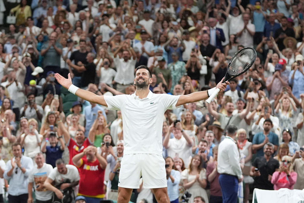 Novak Djokovic of Serbia celebrates winning against Felix Auger-Aliassime of Canada in their quarter-final men's singles match at the Wimbledon Tennis Championships in London, Tuesday, July 7, 2026. (AP Photo/Maja Smiejkowska)
