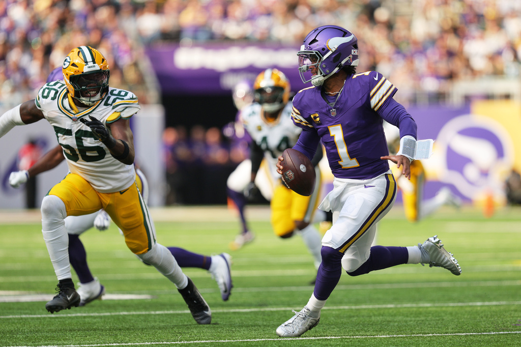 Minnesota Vikings quarterback Kyler Murray (1) scrambles under pressure from Green Bay Packers linebacker Edgerrin Cooper (56) during the first half of an NFL football game, Sunday, Sept. 13, 2026, in Minneapolis, Minn. (AP Photo/Bailey Hillesheim)