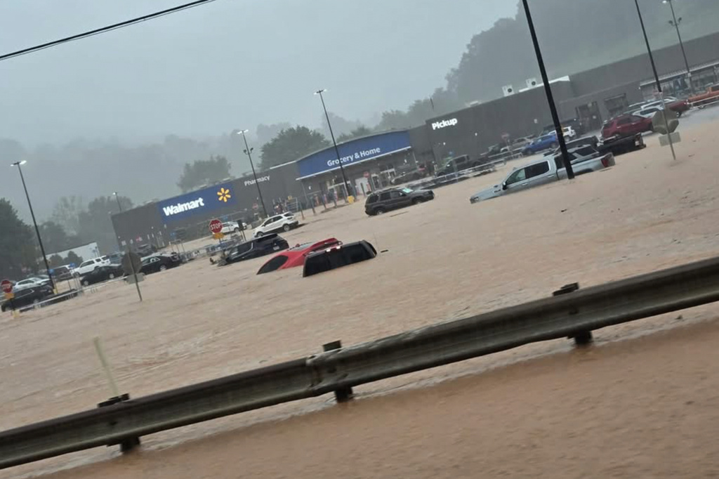 In this photo provided by Alexis Wood, a flooded Walmart parking lot is shown Tuesday, July 21, 2026, in Weston, W.Va. (Alexis Wood via AP)