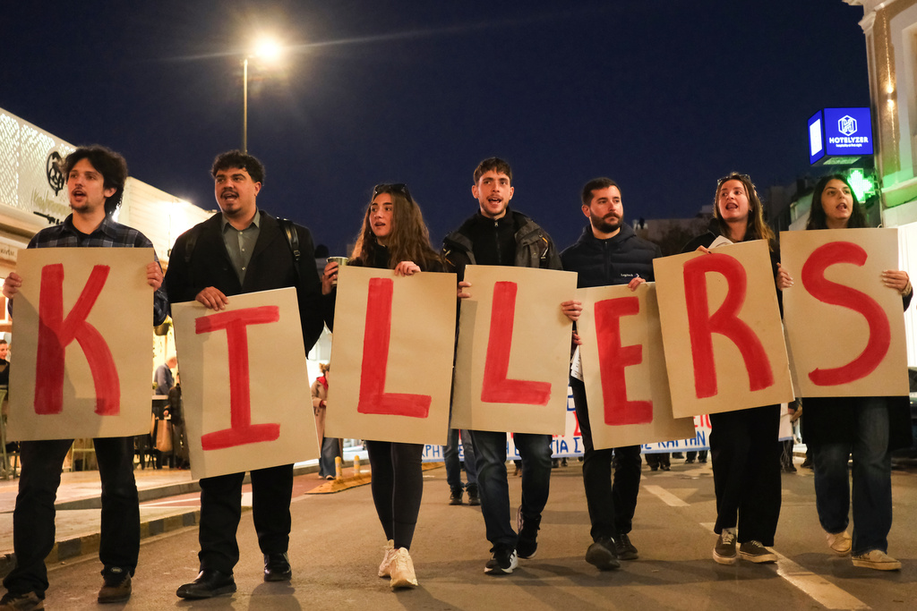 Protesters take part in an anti-war rally in Chania, Greece, opposing the docking of the aircraft carrier USS Gerald R. Ford at the nearby Souda Bay naval base on the southern island of Crete, Tuesday, Feb. 24, 2026. (AP Photo/Giannis Angelakis)