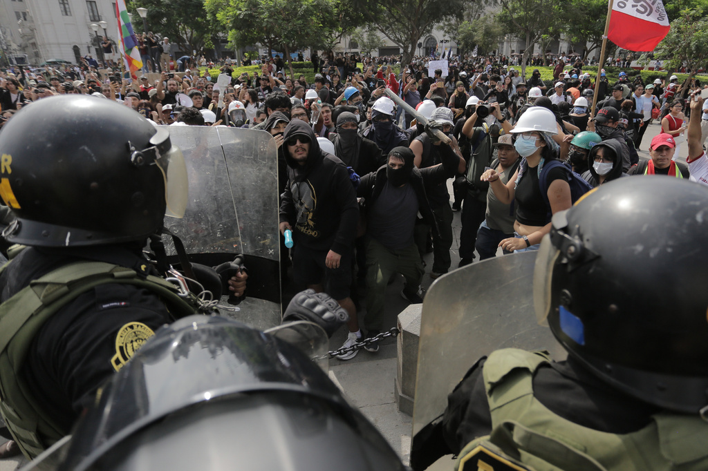 Opponents of Peru's new President Keiko Fujimori confront police during a protest on the day of her inauguration in Lima, Peru, Tuesday, July 28, 2026. (AP Photo/Gerardo Marin)