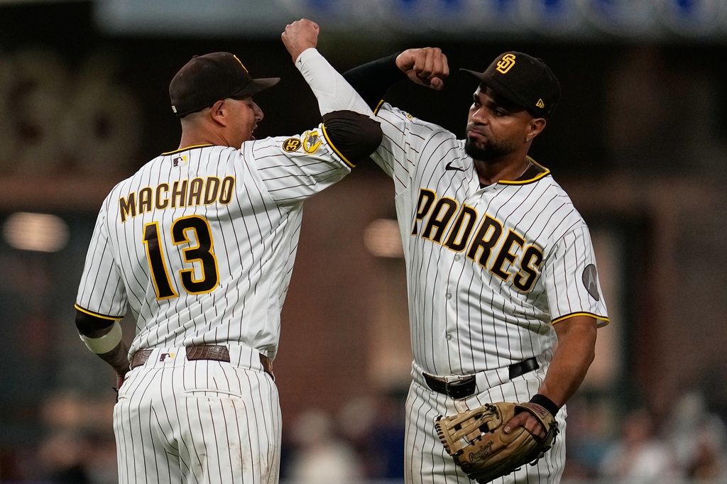 San Diego Padres third baseman Manny Machado (13) celebrates with shortstop Xander Bogaerts after the Padres defeated the Atlanta Braves 1-0 in a baseball game Monday, June 22, 2026, in San Diego. (AP Photo/Gregory Bull)