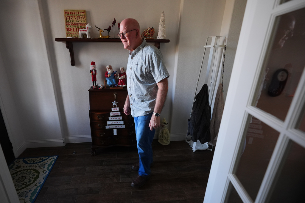 Chuck Dietrick walks to the front door at his home in Anna, Texas, Thursday, Dec. 18, 2025. (AP Photo/LM Otero)