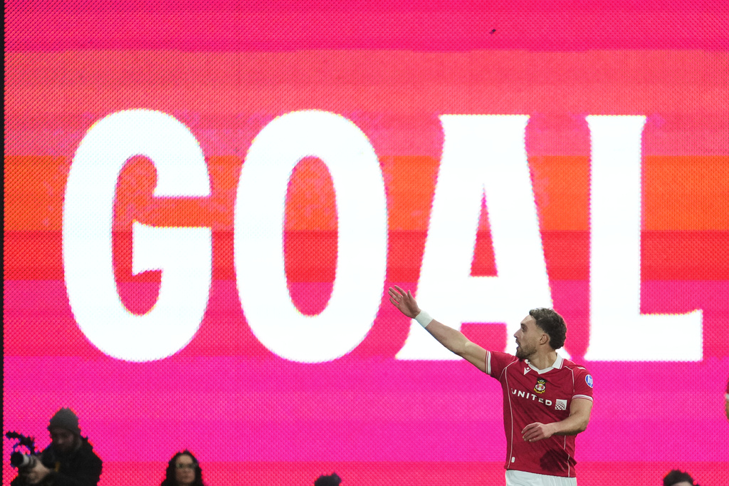 Wrexham's Sam Smith celebrates after scoring during the fifth round FA Cup soccer match between Wrexham and Chelsea in Wrexham, Wales, Saturday, March 7, 2026. (AP Photo/Jon Super)
