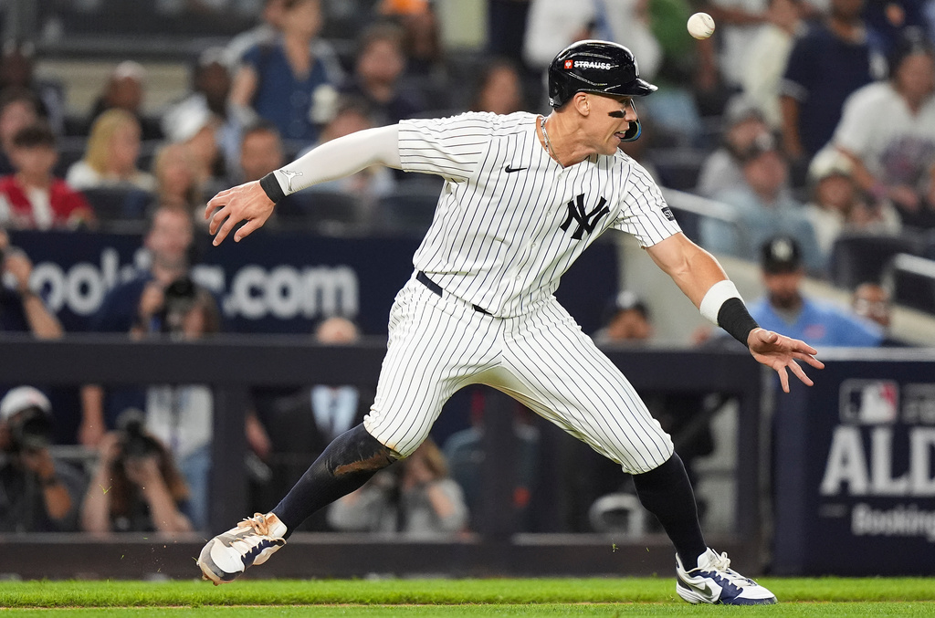 New York Yankees right fielder Aaron Judge gets caught in a rundown between third base and home plate against the Toronto Blue Jays during the third inning of Game 3 of baseball's American League Division Series, Tuesday, Oct. 7, 2025, in New York. (AP Photo/Frank Franklin II)