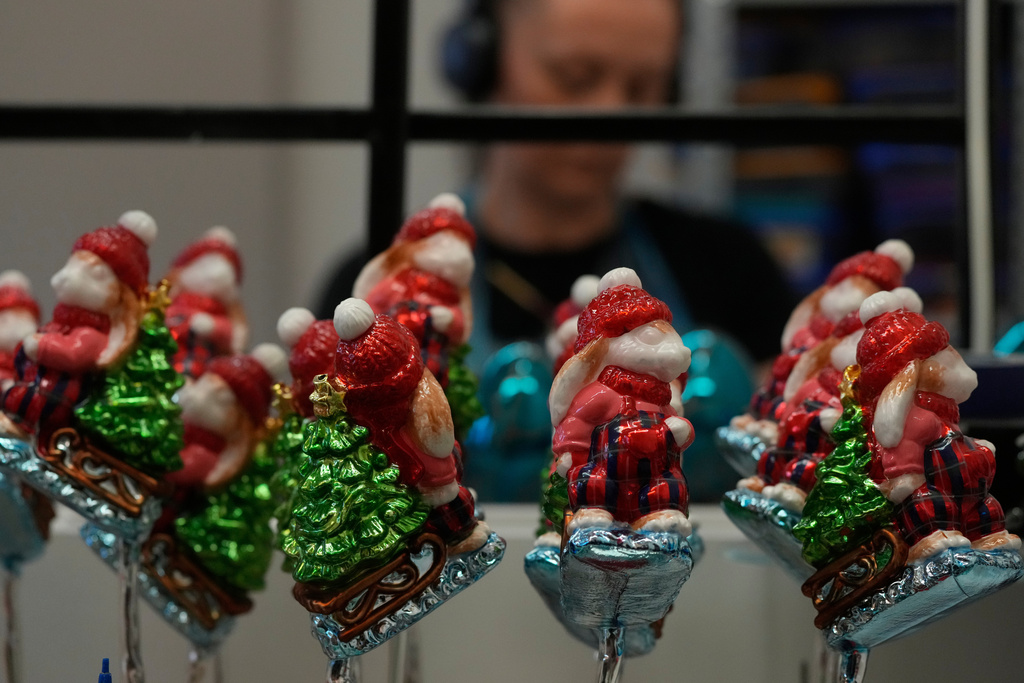 A worker prepares the hand-made Christmas baubles at GlitterLab in Czestochowa, southern Poland, on Nov. 21, 2025. (AP Photo/Czarek Sokolowski)