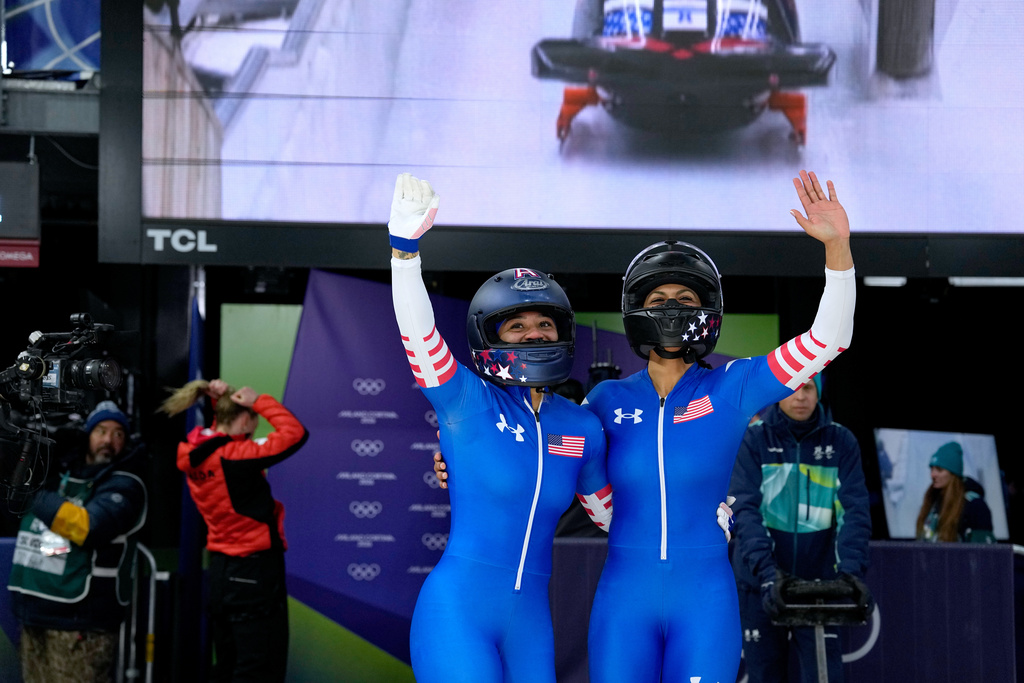 United States' Kaysha Love, right, and Azaria Hill react at the finish during a two women bobsled run at the 2026 Winter Olympics, in Cortina d'Ampezzo, Italy, Friday, Feb. 20, 2026. (AP Photo/Alessandra Tarantino)
