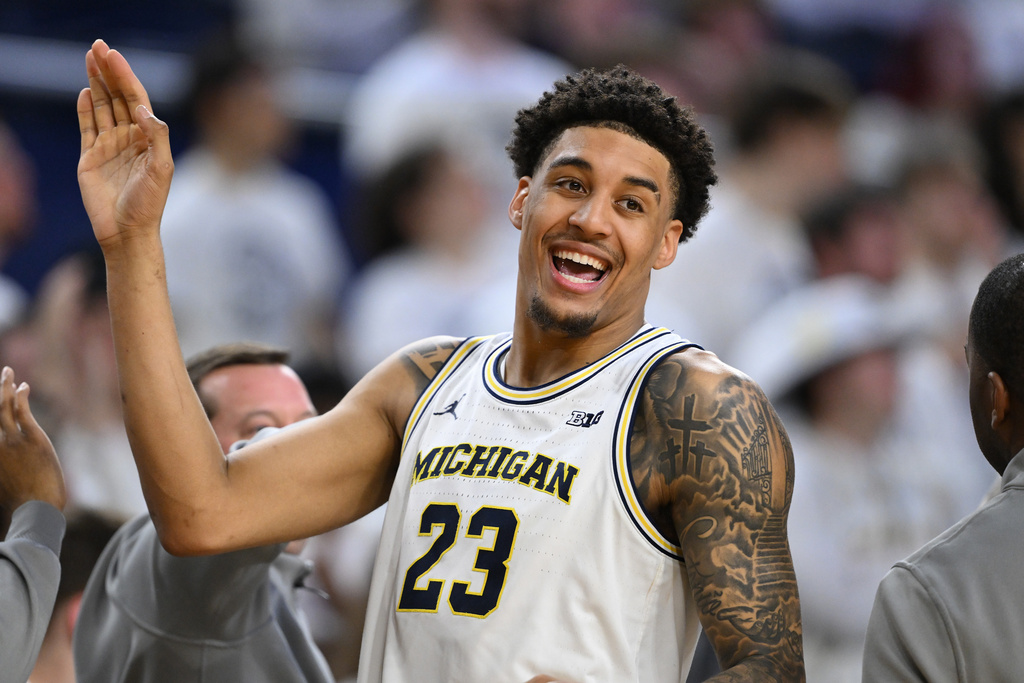 Michigan forward Yaxel Lendeborg (23) smiles as he celebrates with his teammates in the waning seconds of their win over UCLA in an NCAA college basketball game in Ann Arbor, Mich., Saturday, Feb. 14, 2026. (AP Photo/Lon Horwedel)