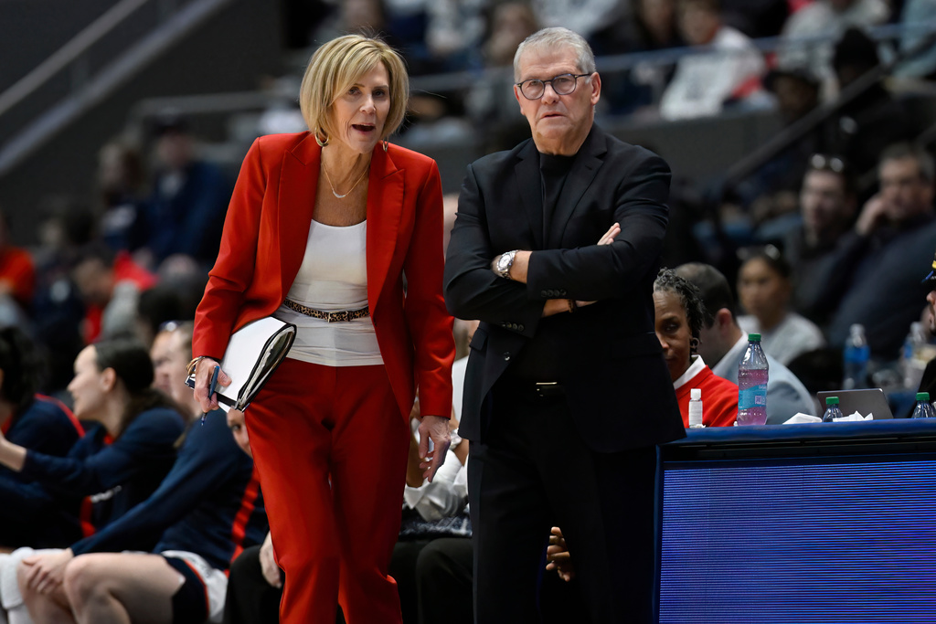 UConn associate head coach Chris Dailey, left, talks with head coach Geno Auriemma, right, in the first half of an NCAA college basketball game against Marquette, Wednesday, Dec. 17, 2025, in Hartford, Conn. (AP Photo/Jessica Hill)