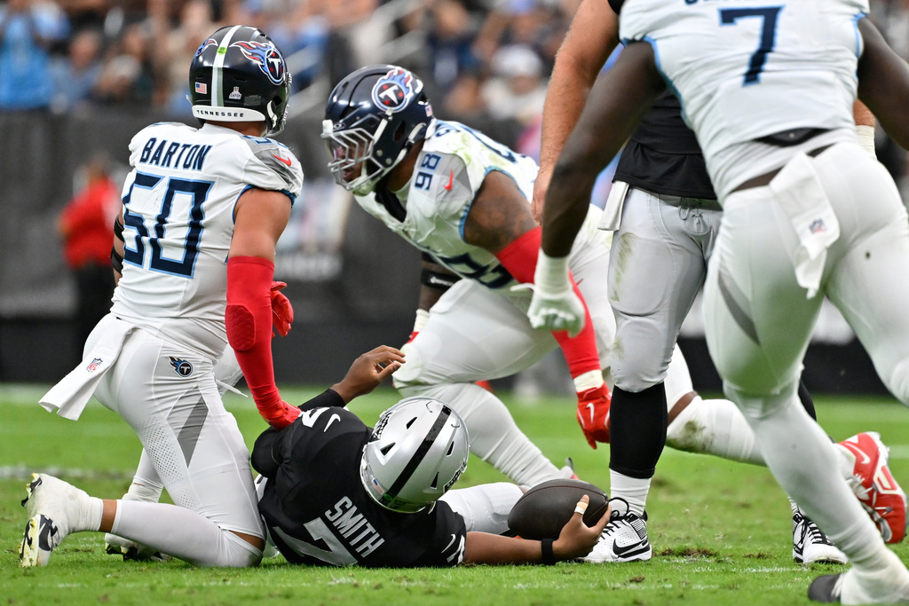 Tennessee Titans defensive tackle Jeffery Simmons (98) celebrates after sacking Las Vegas Raiders quarterback Geno Smith (7) during the first half of an NFL football game, Sunday, Oct. 12, 2025, in Las Vegas. (AP Photo/David Becker)