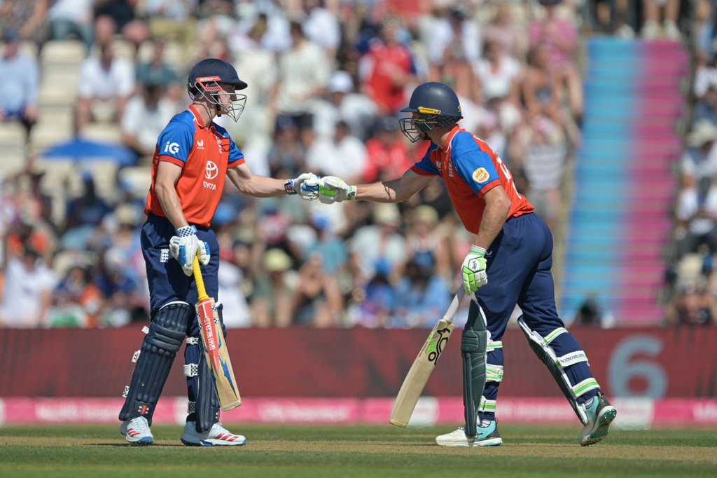 England's Jos Butler, right is congratulated by teammate Harry Brook after hitting a six during the international T20 Cricket match between England and India In Southampton, England, Saturday, July 11, 2026. (AP Photo/Anthony Upton)