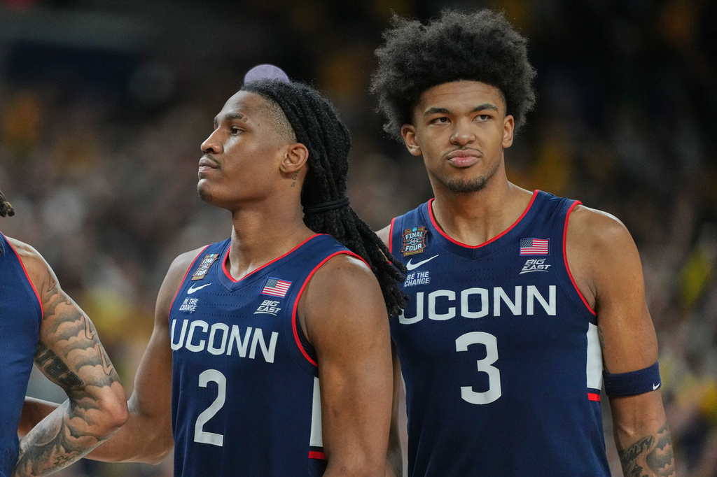 UConn's Silas Demary Jr. (2) and Jaylin Stewart reactsafter losing to Michigan in the NCAA college basketball tournament national championship game at the Final Four, Monday, April 6, 2026, in Indianapolis. (AP Photo/Michael Conroy)