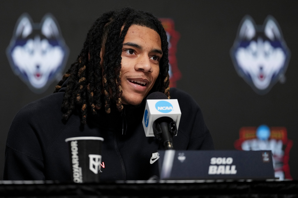 UConn guard Solo Ball speaks during a news conference ahead of a national championship NCAA college basketball tournament game against Michigan at the Final Four, Sunday, April 5, 2026, in Indianapolis. (AP Photo/Jeff Roberson)