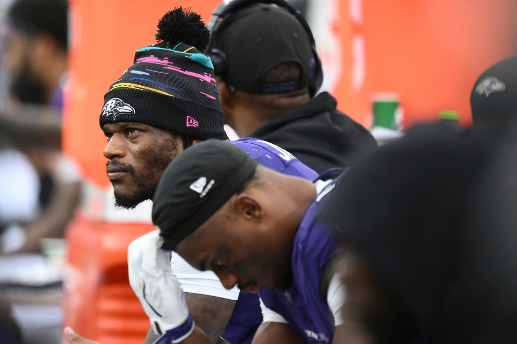 Baltimore Ravens quarterback Lamar Jackson, left, looks out from the bench during the second half of an NFL football game against the Tennessee Titans in Baltimore, Sunday, Oct. 4, 2026. (AP Photo/Nick Wass)