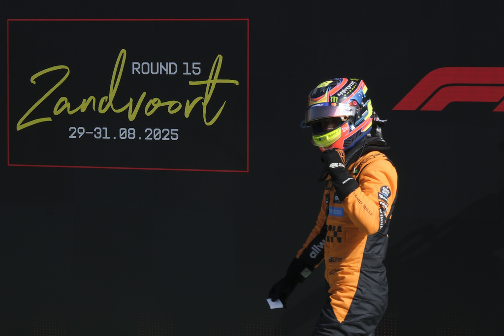 McLaren driver Oscar Piastri of Australia celebrates his pole position after the qualifying session ahead of the Formula One Dutch Grand Prix at the Zandvoort racetrack in Zandvoort, Netherlands, Saturday, Aug. 30, 2025. (AP Photo/Patrick Post)