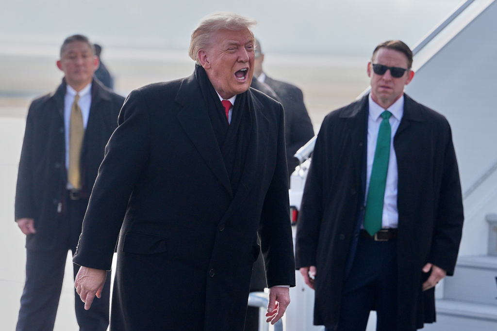 President Donald Trump, center, speaks as he steps off Air Force One after arriving at Zurich International Airport for the World Economic Forum, Wednesday, Jan. 21, 2026, in Zurich, Switzerland. (AP Photo/Evan Vucci)
