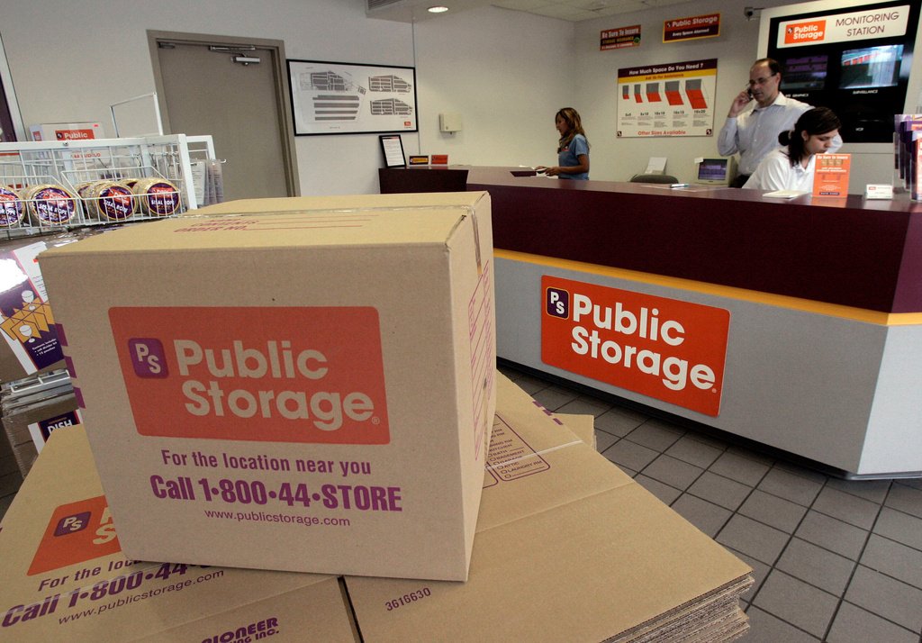 FILE - Carol Avalos, far left, Wes Demory, center, and Desiree Mora working at the customer service desk for Public Storage, Inc. on March 7, 2006, in the Eagle Rock section of Los Angeles. (AP Photo/Ric Francis, File)