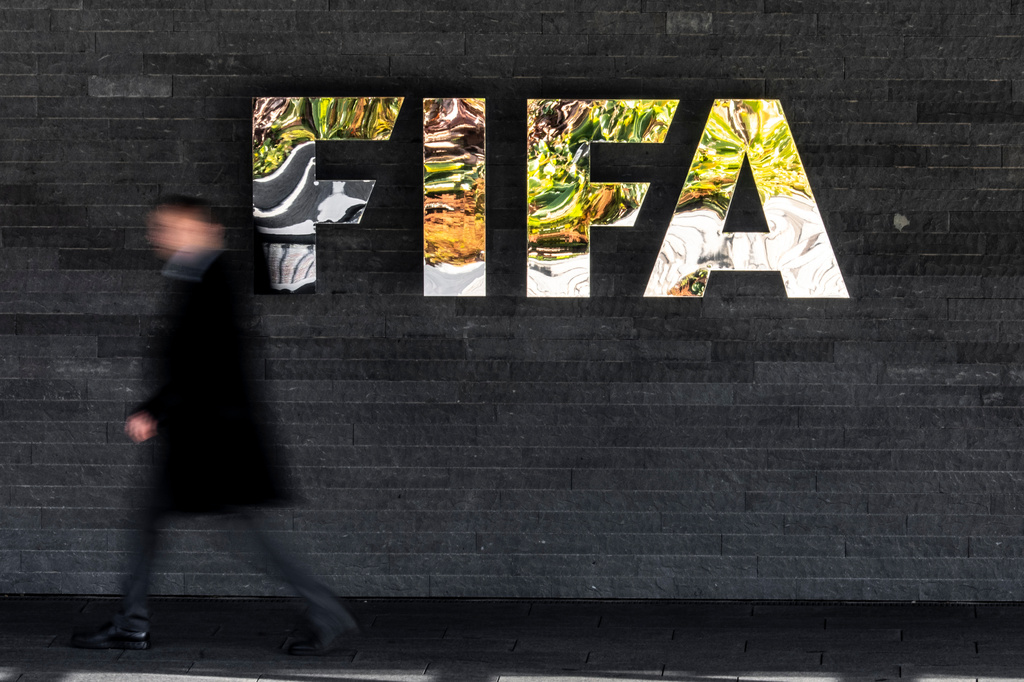 A man walks past a FIFA sign at the headquarters during the FIFA council meeting, in Zurich, Switzerland, Thursday, Oct. 15, 2026. (Claudio Thoma/Keystone via AP)