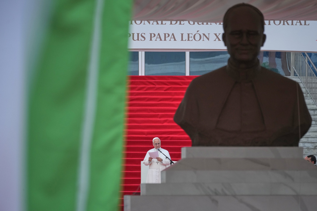 Pope Leo XIV, framed by a bust dedicated to him, delivers his speech as he meets with representatives of the world of culture at the Leon XIV Campus of the National University in Malabo, Equatorial Guinea, Tuesday, April 21, 2026, on the ninth day of his 11-day pastoral visit to Africa. (AP Photo/Andrew Medichini)