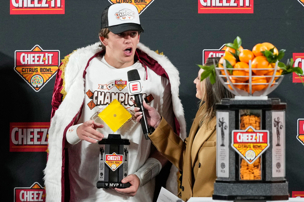 Texas quarterback Arch Manning makes remarks to fans after winning the MVP award in the Citrus Bowl NCAA college football game against Michigan, Wednesday, Dec. 31, 2025, in Orlando, Fla. (AP Photo/John Raoux)