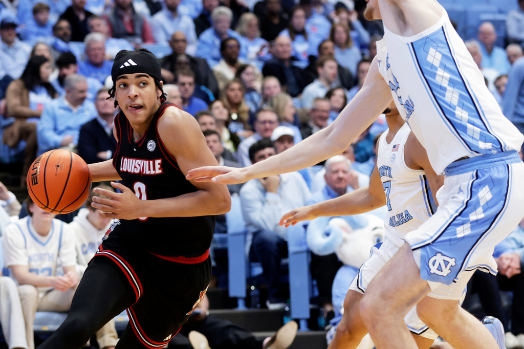 FILE - Louisville guard Mikel Brown Jr. (0) drives against North Carolina center Henri Veesaar, right, during the second half of an NCAA college basketball game, Feb. 23, 2026, in Chapel Hill, N.C. (AP Photo/Chris Seward, File)