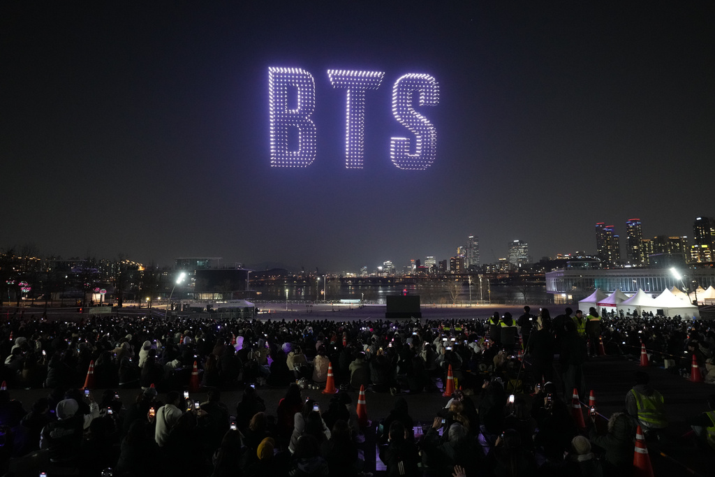 Drones light up the night sky during a drone light show to celebrate the comeback of the K-pop band BTS at a park along the Han River in Seoul, South Korea, Friday, March 20, 2026. (AP Photo/Lee Jin-man)