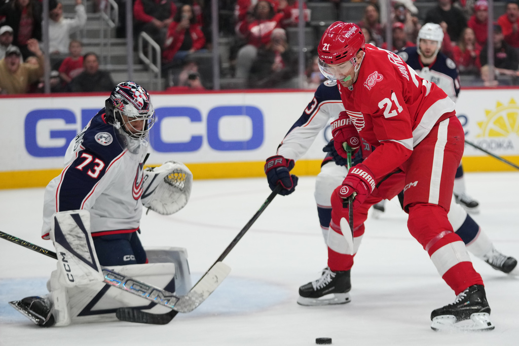 Columbus Blue Jackets goaltender Jet Greaves (73) stops a Detroit Red Wings left wing James van Riemsdyk (21) shot in the second period of an NHL hockey game Tuesday, April 7, 2026, in Detroit. (AP Photo/Paul Sancya)