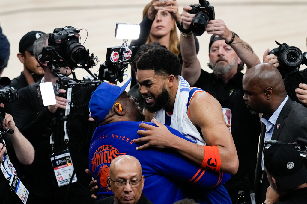 New York Knicks center Karl-Anthony Towns hugs his dad, Karl-Anthony Towns Sr., after Game 2 of the NBA Finals basketball series against the San Antonio Spurs, Friday, June 5, 2026, in San Antonio. (AP Photo/David J. Phillip)