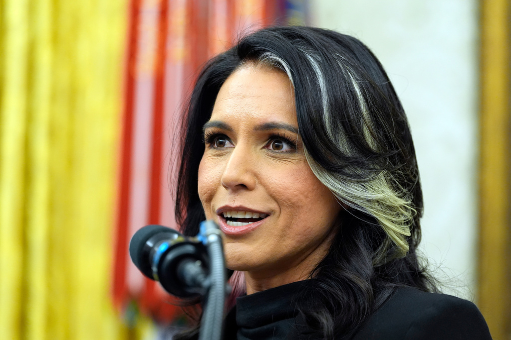 FILE - Tulsi Gabbard listens to President Donald Trump as she is sworn in as the Director of National Intelligence in the Oval Office of the White House, Feb. 12, 2025, in Washington. (Photo/Alex Brandon, File)