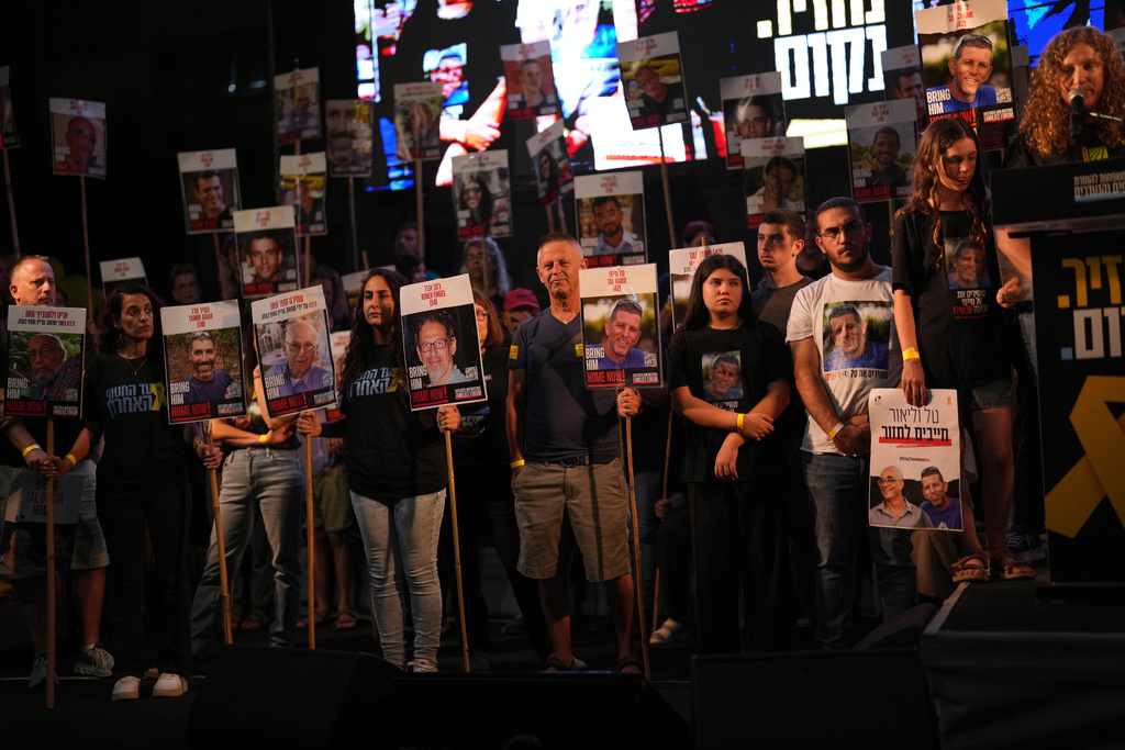 People take part in a rally demanding the returning of the bodies of hostages kidnapped by Hamas who are still in Gaza Strip, at a plaza known as hostages square, in Tel Aviv, Israel, Saturday, Oct. 18, 2025. (AP Photo/Francisco Seco)
