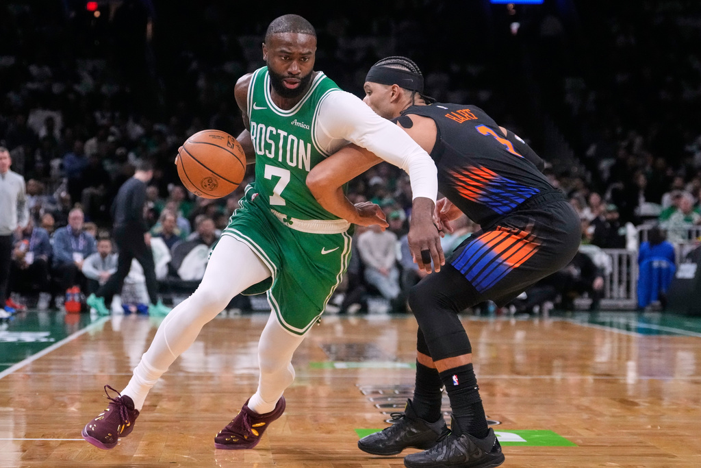 Boston Celtics guard Jaylen Brown (7) drives around New York Knicks guard Josh Hart (3) during the first half of an NBA basketball game, Tuesday, Dec. 2, 2025, in Boston. (AP Photo/Charles Krupa)