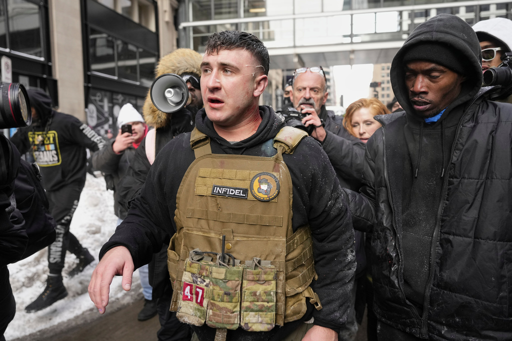 FILE - Jake Lang, center, walks away from counter protesters after an altercation near Minneapolis City Hall, Saturday, Jan. 17, 2026, in Minneapolis. (AP Photo/Yuki Iwamura,File)