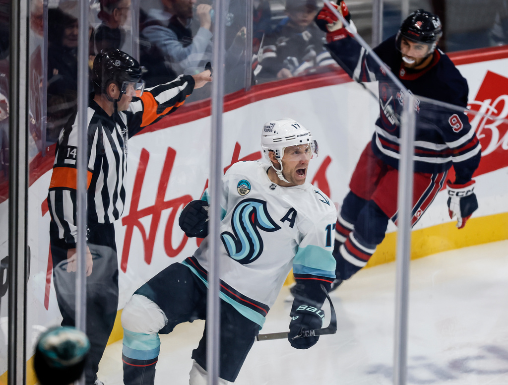 Seattle Kraken's Jaden Schwartz (17) celebrates his goal against the Winnipeg Jets during second period NHL action in Winnipeg on Thursday, October 23, 2025. (John Woods/The Canadian Press via AP)