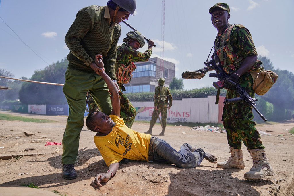 A protester is arrested by anti-riot police during a demonstration against a proposed Ebola quarantine center to be established by the United States at Laikipia Air Base in Nanyuki, Kenya, Tuesday, June 9, 2026. (AP Photo/Brian Inganga)
