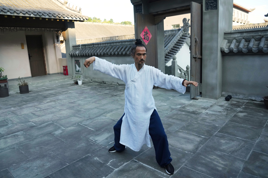 Yuan Shimao, founder of Wudang Taoist Traditional Kung Fu Academy, performs on the grounds of the academy near Wudang Mountain in Shiyan city in central China's Hubei province on Friday, Sept. 4, 2026. (AP Photo/Achmad Ibrahim)