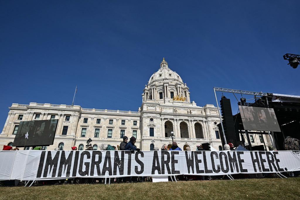 People attend the "No Kings" protest Saturday, March 28, 2026, in St. Paul, Minn. (AP Photo/Tom Baker)