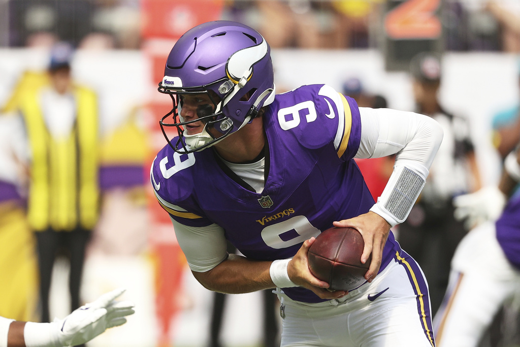 Minnesota Vikings quarterback J.J. McCarthy takes a snap during the first half of an NFL preseason football game against the Houston Texans, Saturday, Aug. 9, 2025, in Minneapolis. (AP Photo/Matt Krohn)