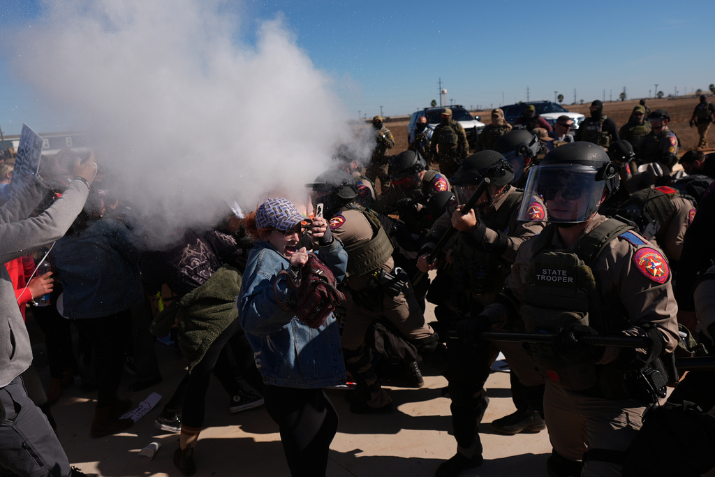 Pepper spray is used by Texas troopers to disperse protesters outside the South Texas Family Residential Center detention facility where Liam Ramos and his father are being detained in Dilley, Texas, Wednesday, Jan. 28, 2026. (AP Photo/Eric Gay)