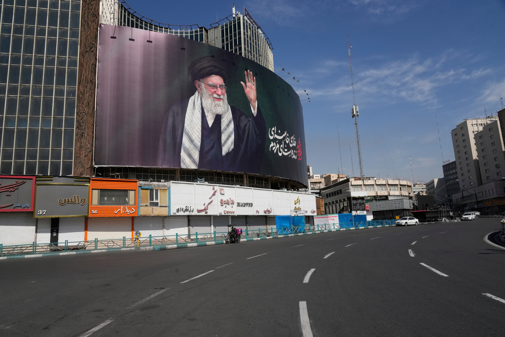 A billboard showing a portrait of the late Iranian Supreme Leader Ayatollah Ali Khamenei, who was killed in U.S.-Israeli strikes, looms over an empty square in Tehran, Iran, Thursday, March 5, 2026. (AP Photo/Vahid Salemi)