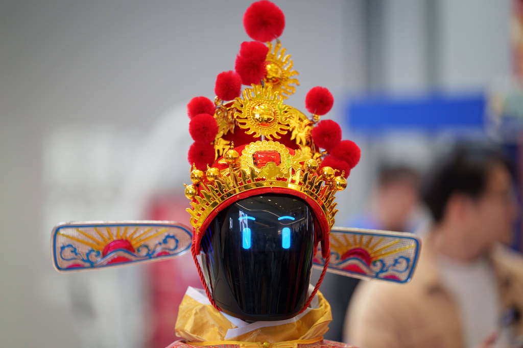 A humanoid robot wearing a traditional headdress is displayed during a media preview of a robotic temple fair celebrated ahead of Lunar New Year in Beijing, China, Friday, Feb. 13, 2026. (AP Photo/Vincent Thian)