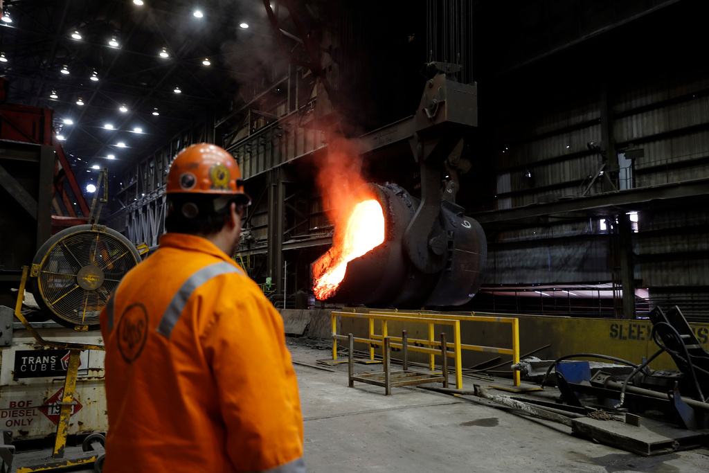 FILE - In this June 28, 2018 photo, senior melt operator Randy Feltmeyer watches a giant ladle as it backs away after pouring its contents of red-hot iron into a vessel in the basic oxygen furnace as part of the process of producing steel at the U.S. Steel Granite City Works facility in Granite City, Ill. (AP Photo/Jeff Roberson, File)
