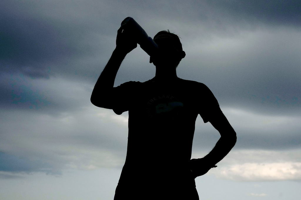 Paul Grinvalds, of West Des Moines, Iowa, takes a drink after a run with the Raccoon River Running Club, Sunday, Aug. 9, 2026, in West Des Moines, Iowa. (AP Photo/Charlie Neibergall)