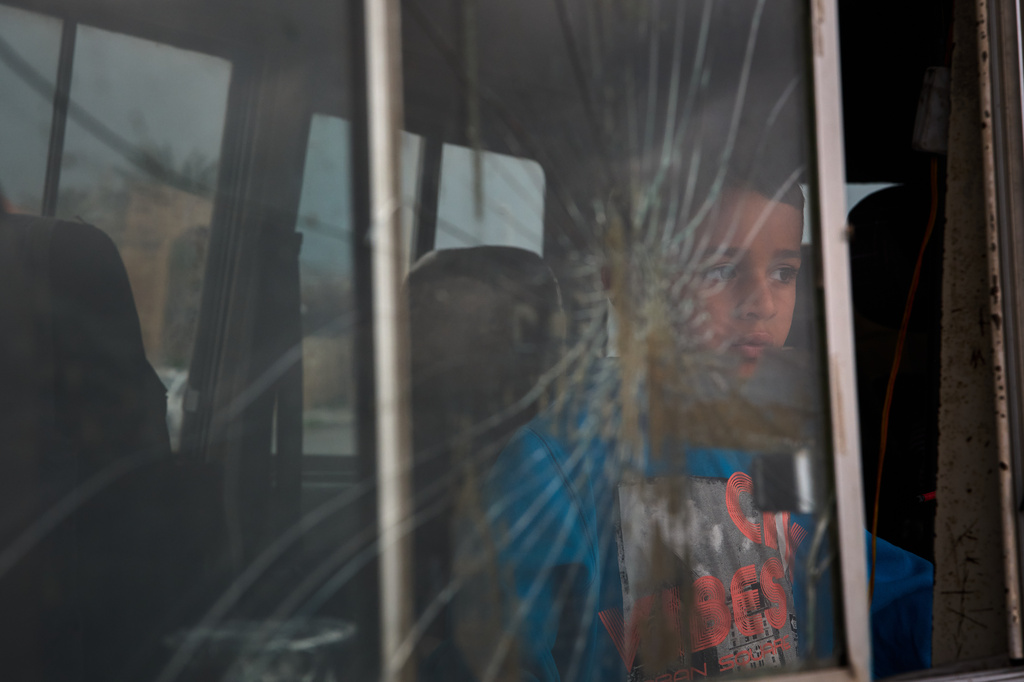 A boy who fled with his family following Israeli strikes in southern Lebanon sits inside the van they are using as shelter in Sidon, Lebanon, Thursday, April 2, 2026. (AP Photo/Emilio Morenatti)