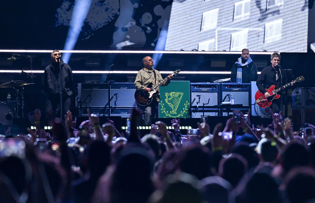 FILE - Liam Gallagher, from left, Paul Arthurs and Noel Gallagher of Oasis perform on Sunday, Aug. 31, 2025, at MetLife Stadium in East Rutherford, N.J. (Photo by Evan Agostini/Invision/AP, File)