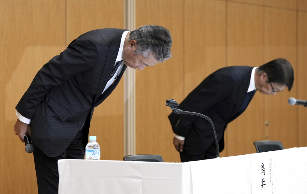 Suntory Holdings President Nobuhiro Torii, left, and Vice President Kenji Yamada, right, bow during a press conference regarding the resignation of Takeshi Niinami, not in photo, chief executive of Japan’s major beverage maker Suntory, in Tokyo, Tuesday, Sept. 2, 2025. (Kyodo News via AP)
